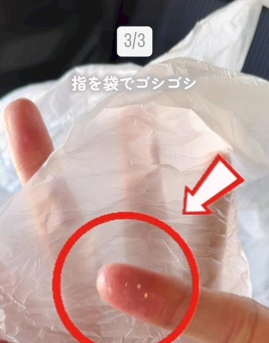 手に付いた油をビニール袋にこすり付けている様子