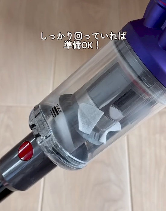 小さくカットしたフローリングシートが入った掃除機のダストカップ