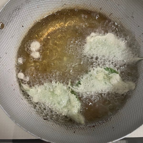 衣を付けた大葉を油で揚げる様子