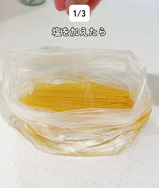 半分に折ったパスタと水を入れた『アイラップ』に塩を入れた様子