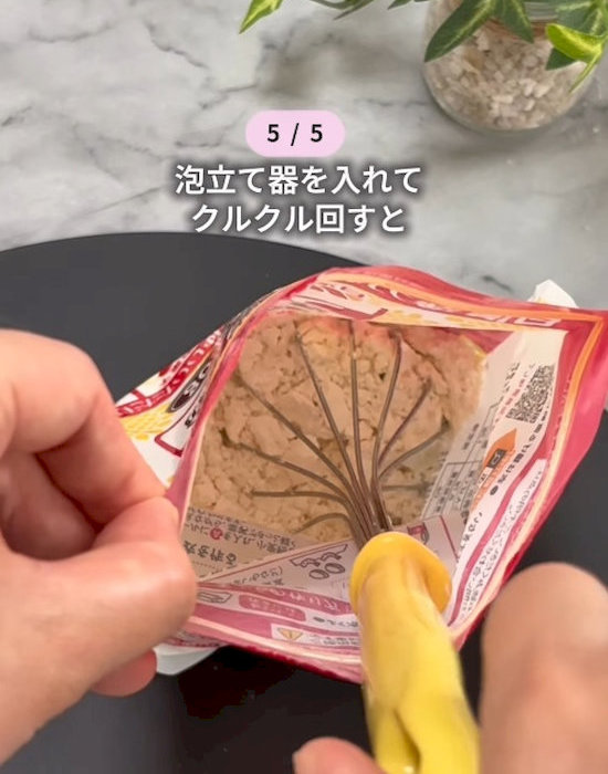 小麦粉の袋の中に泡立て器を入れている様子