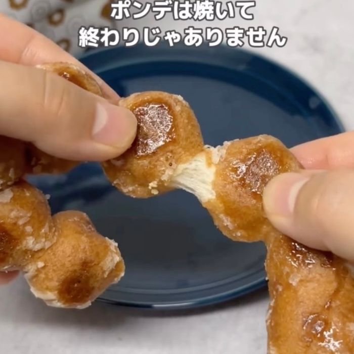 焼いた『ポン・デ・リング』を手でちぎる様子