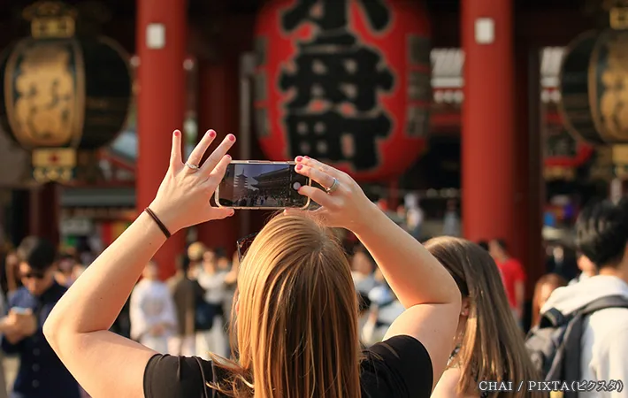 観光地で写真を撮る女性の写真