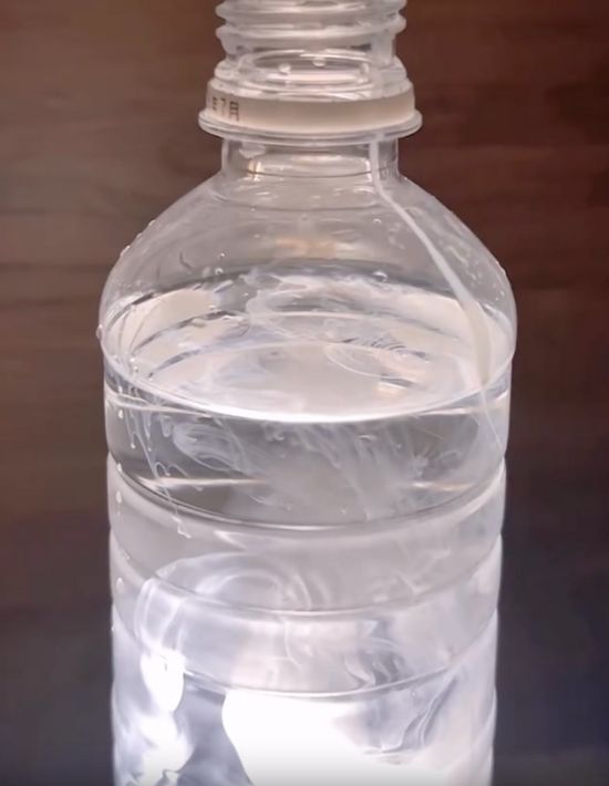 ペットボトルに入れた牛乳が水の中で広がる様子