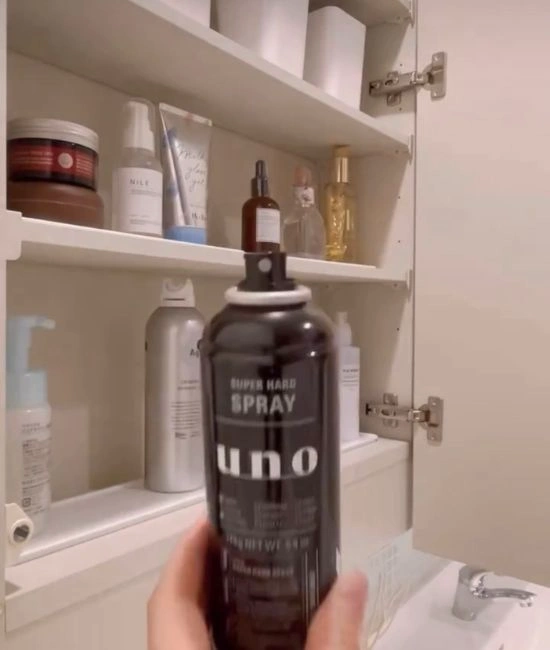 ヘアスプレーの蓋を外す様子