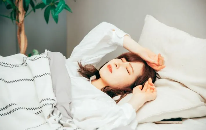 朝になかなか起きられない女性の写真