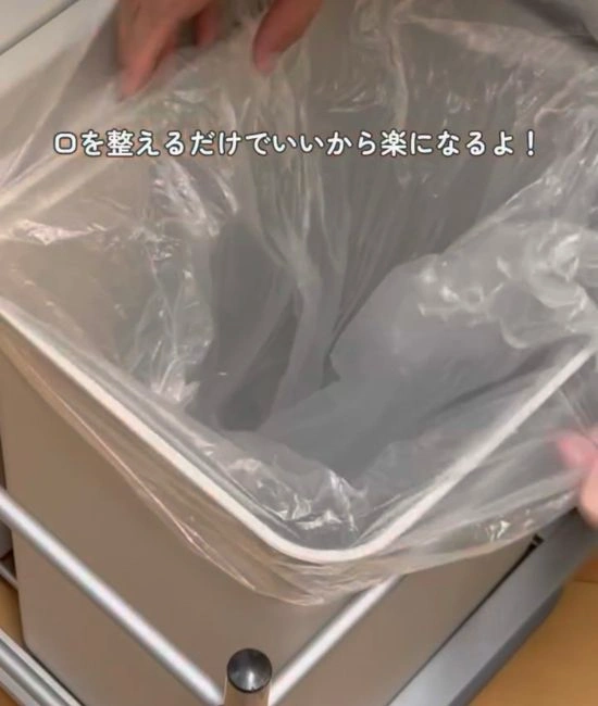 ゴミ袋の口を広げる様子