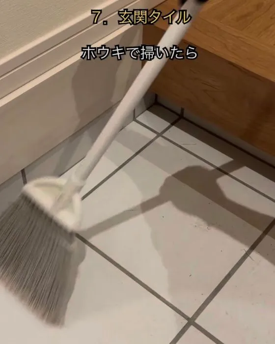 玄関のゴミを掃く様子