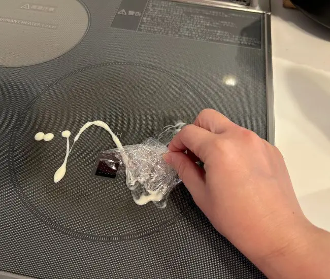 ラップでIHを擦っている様子（撮影：grapeライフハック編集部）