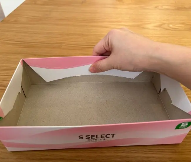 ティッシュ箱を両面テープでとめている様子（撮影：grapeライフハック編集部）