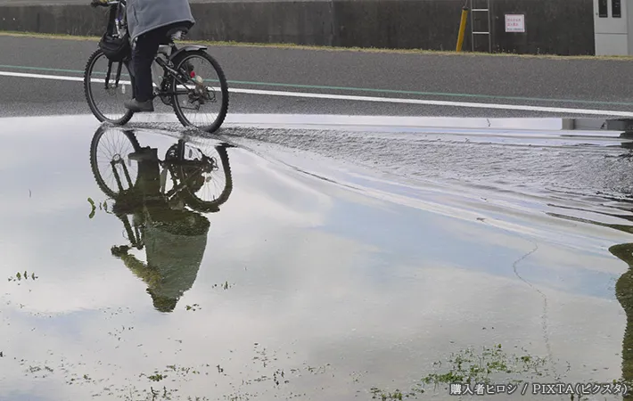 『水たまり』の横を通る自転車の写真