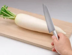 『Radish and knife on a cutting board』の写真