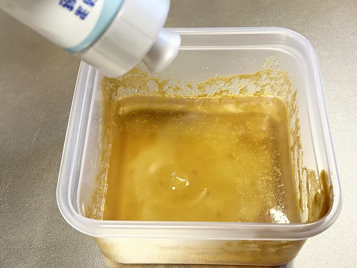 汚れたプラ容器に洗剤を入れている画像（撮影：grapeライフハック編集部）