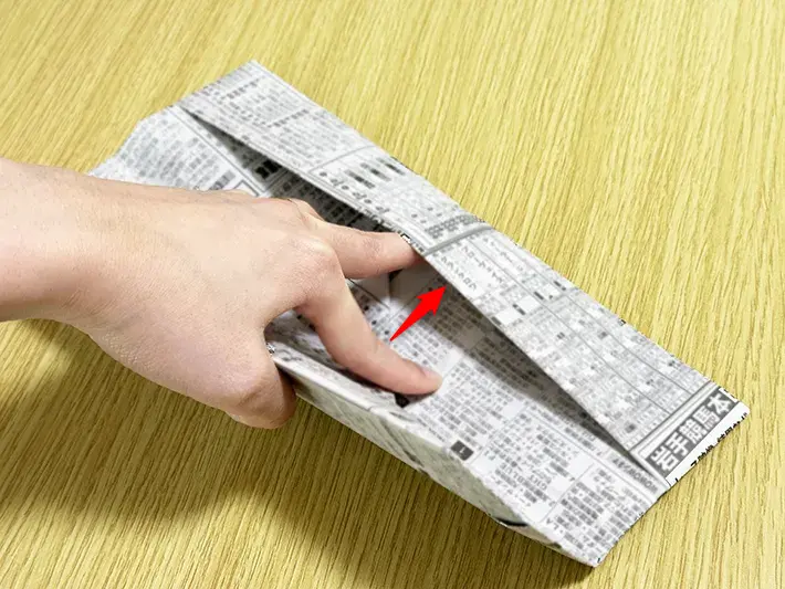 新聞紙の上のポケットに下側を入れ込んだ画像（撮影：grapeライフハック編集部）