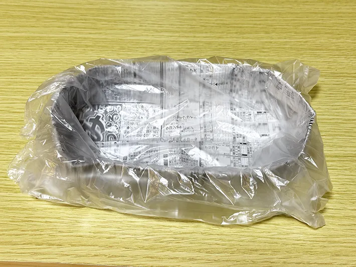 新聞紙の皿に『アイラップ』を被せている画像（撮影：grapeライフハック編集部）