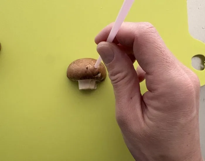 マッシュルームの傘にストローを刺して目を作っている様子