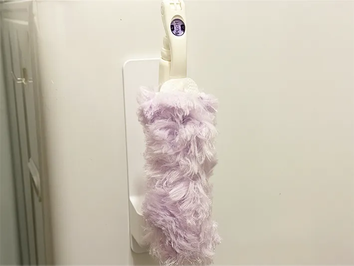 『ダイソー』の『シャワーホルダー』に『クイックルハンディ』を収納した画像（撮影：grapeライフハック編集部）