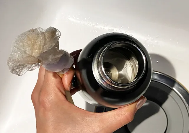 割り箸に水切りネットを巻きつけて、水筒を洗った後の場面（撮影：grape編集部）