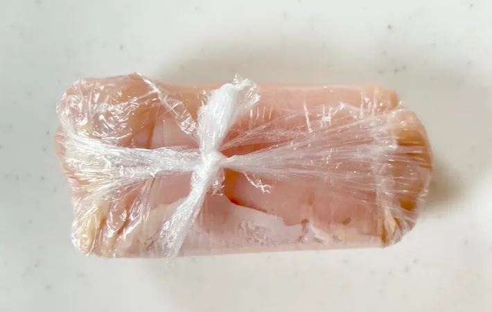 鶏むね肉を包んだラップの端と端を結んだ画像