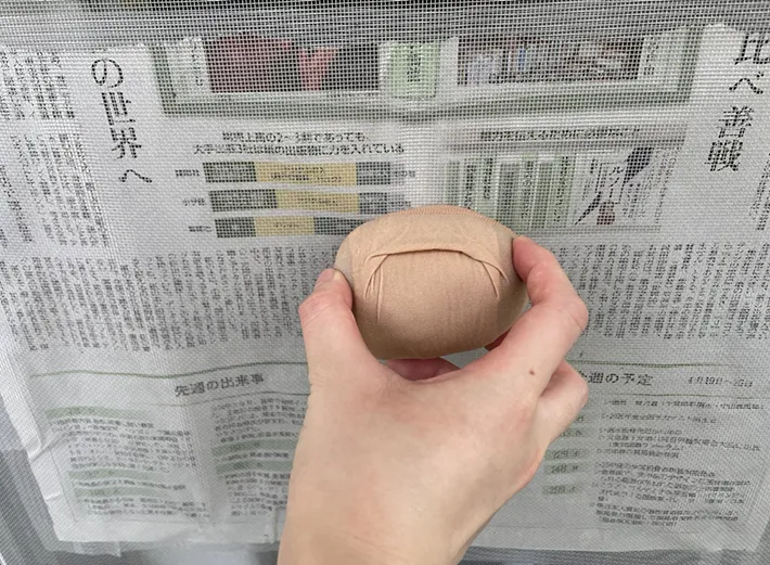 『ストッキング団子』で網戸を掃除する写真（撮影：grapeライフハック編集部）