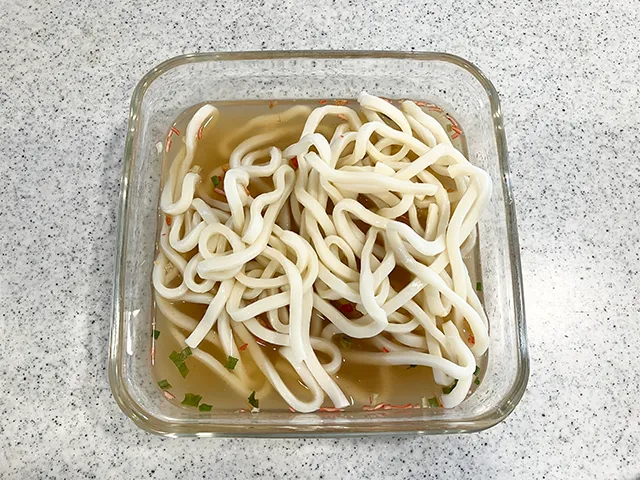 五目チャーハンの素と水を混ぜ、うどんを入れた場面（撮影：grapeフード編集部）