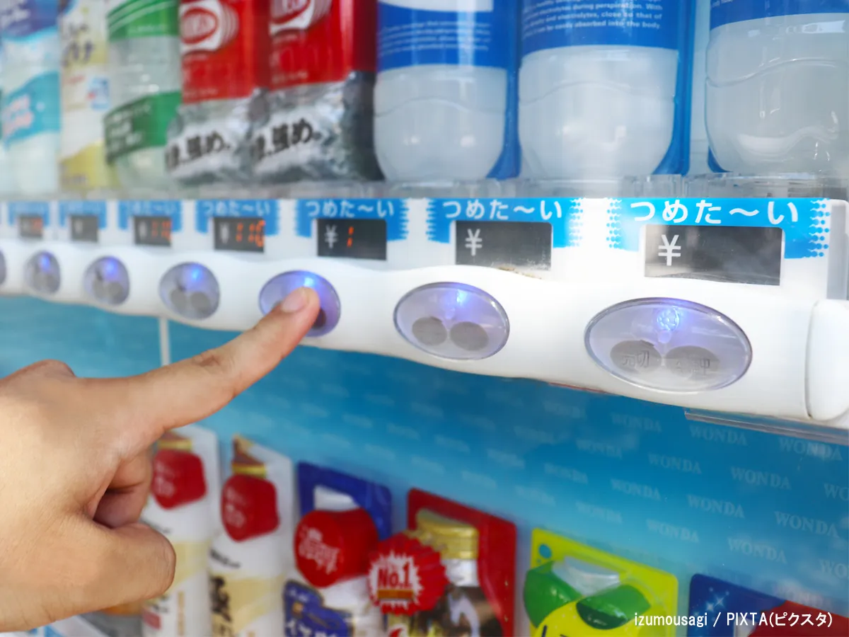 自動販売機でジュースを購入する手元