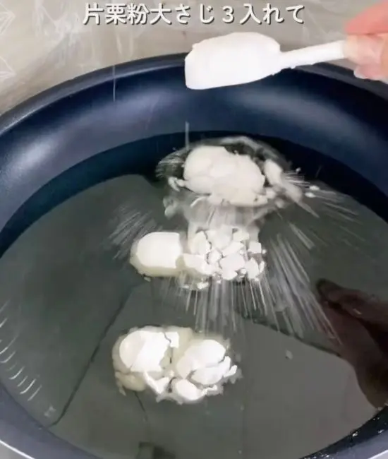 フライパンの油に片栗粉を加えている様子