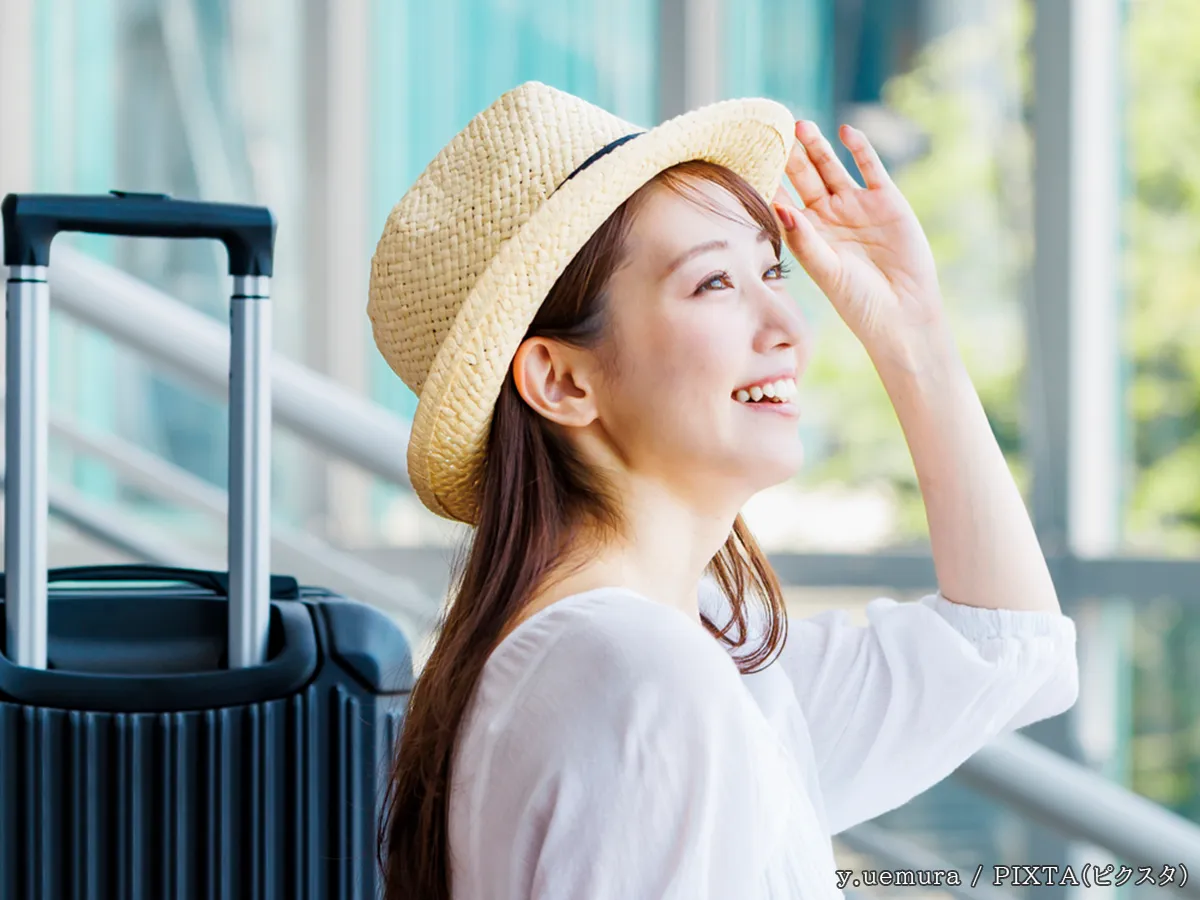 女性とスーツケースの写真
