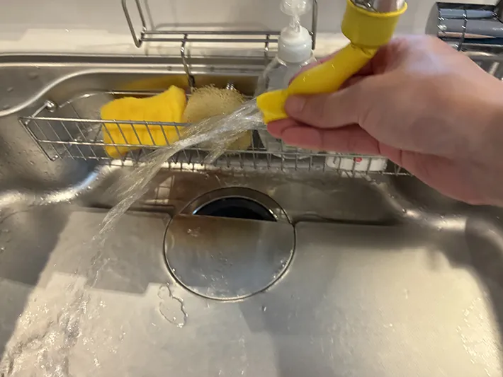 蛇口につけた風船を使ってシンクを洗い流す場面（撮影：grapeライフハック編集部）
