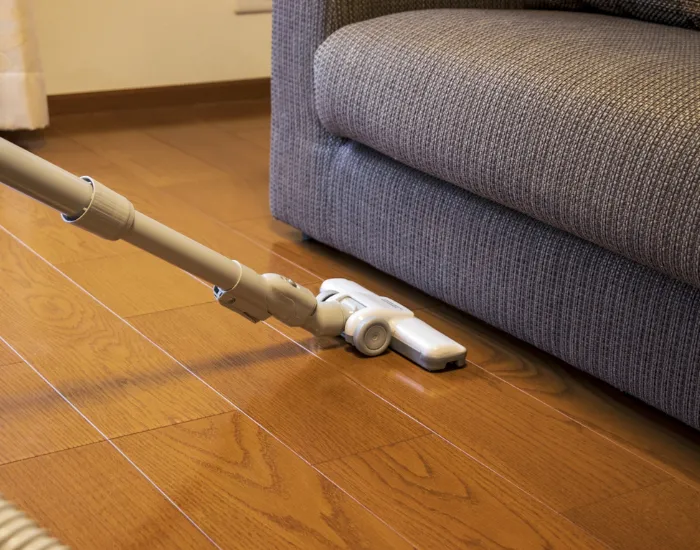ソファの周りを掃除する様子