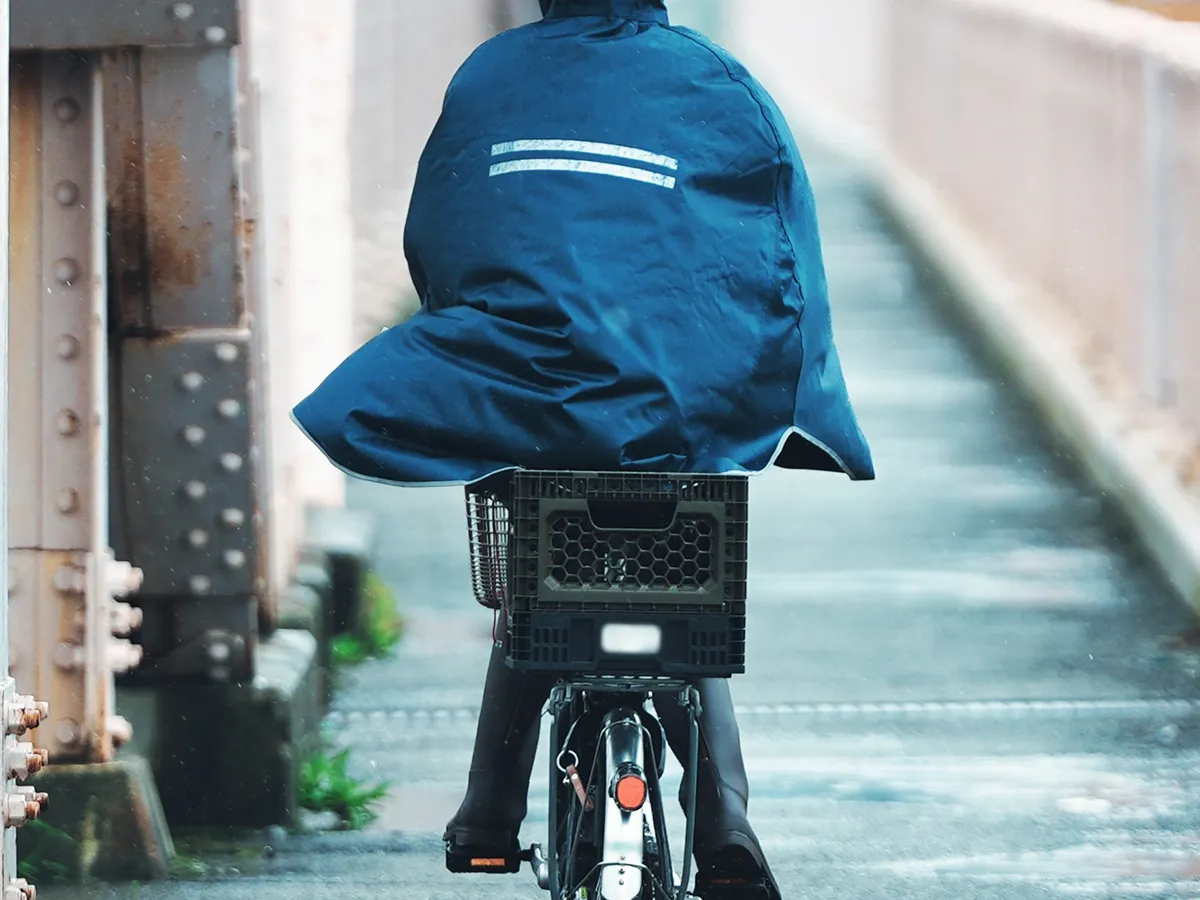 自転車とレインコートを着た人の写真