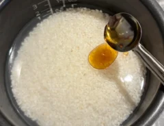 研いだお米にごま油を加える場面（撮影：grapeフード編集部）