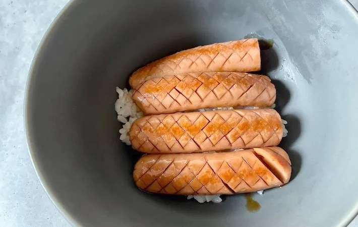 焼いた魚肉のソーセージをご飯の上にのせた画像（撮影：エニママ）