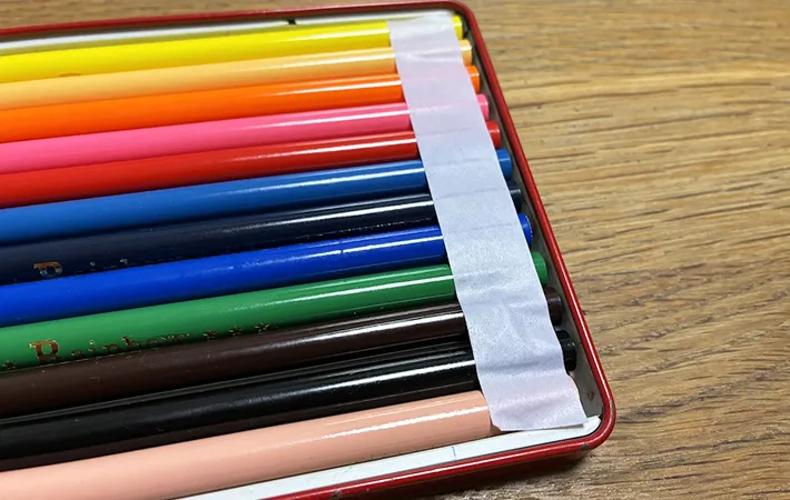 箱に入った色鉛筆にマスキングテープを貼った画像（撮影：エニママ）