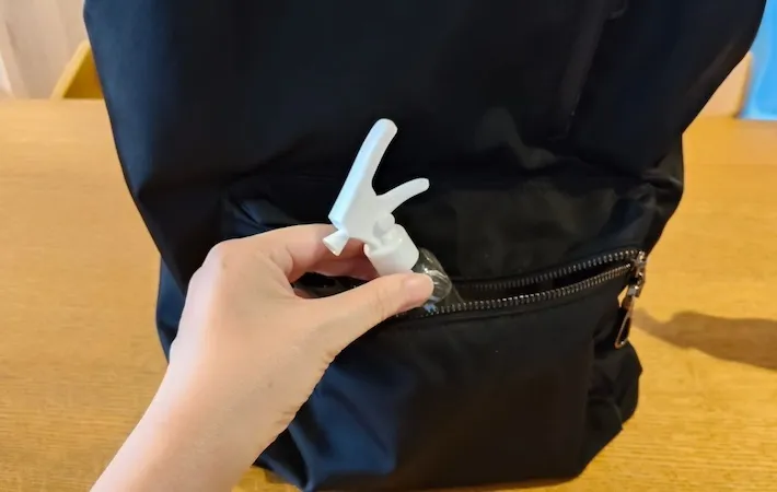 スプレーボトルをリュックの前のポケットに入れている画像（撮影：エニママ）