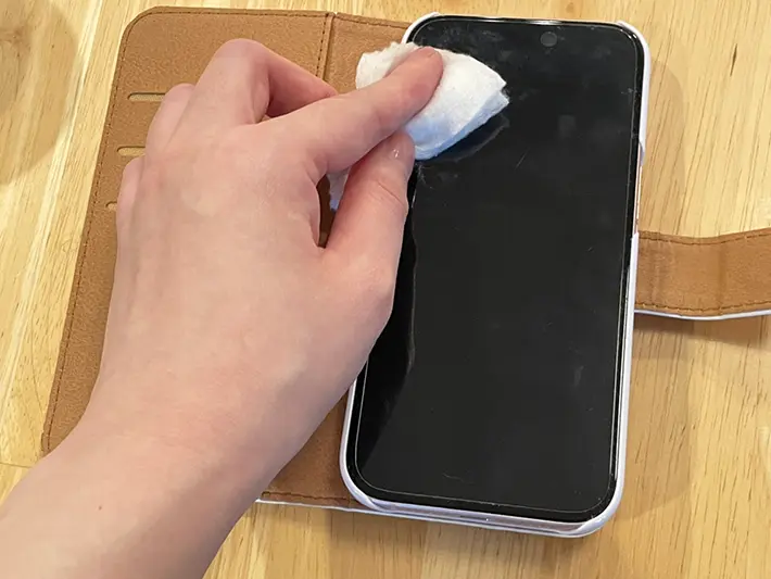 汚れたスマホの画面をコットンで拭く写真（撮影：grapeライフハック編集部）