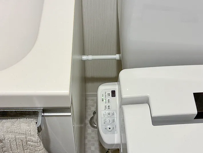 トイレのタンクと洗面台の間に設置した短いつっぱり棒（撮影：grapeライフハック編集部）