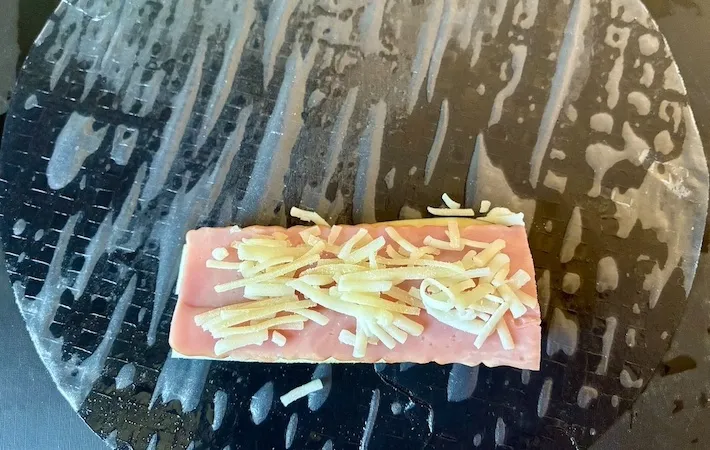なすの上にベーコンとチーズを載せる画像（撮影：エニママ）
